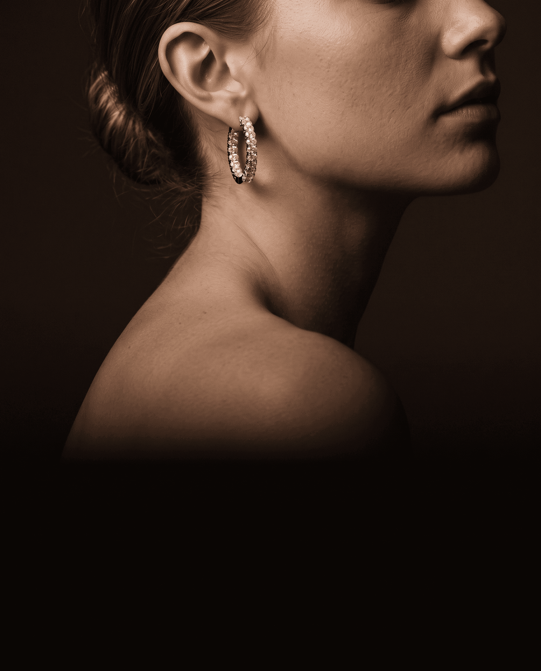 Diamond drop earrings worn against a dark espresso backdrop