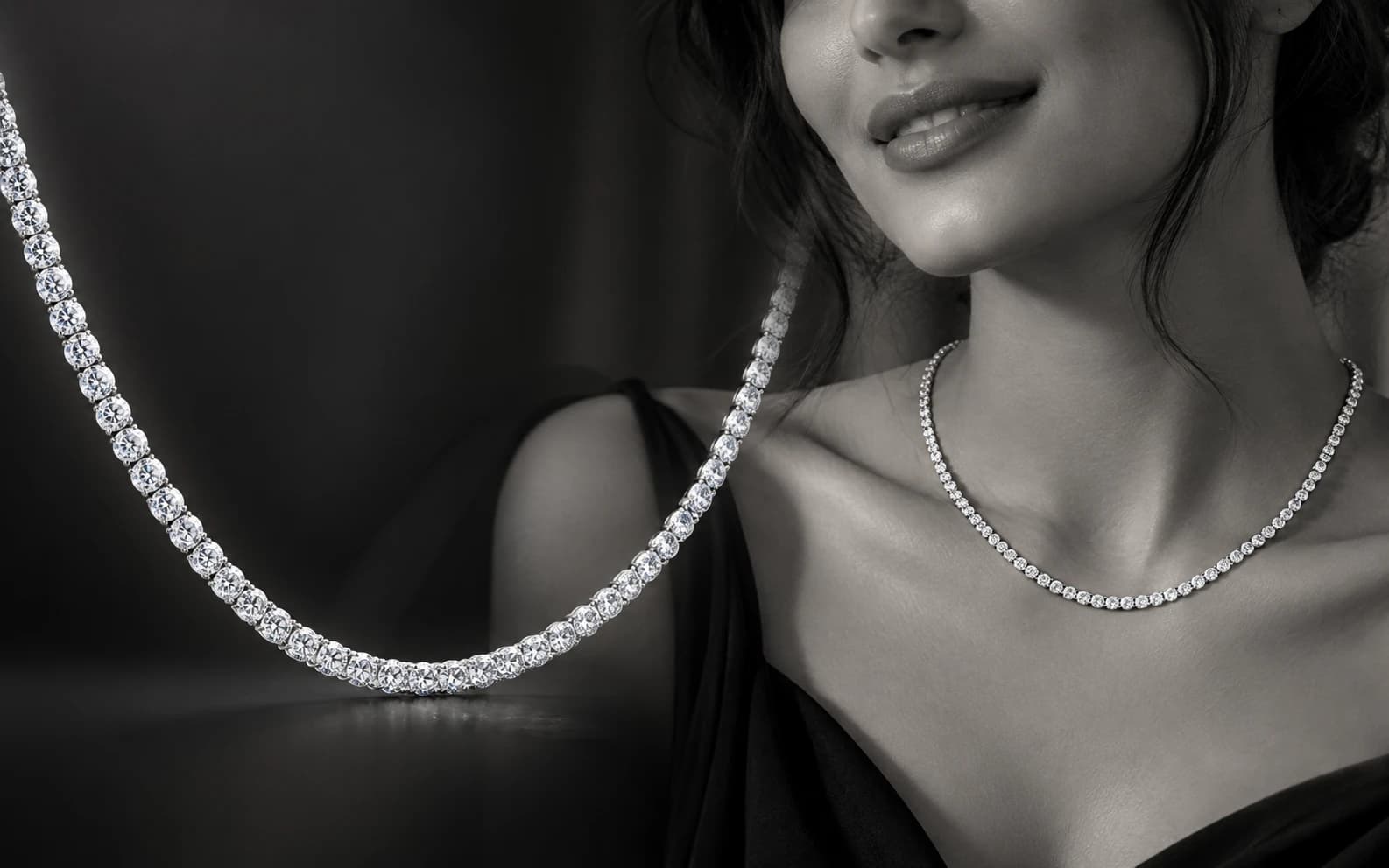 Black-and-white portrait of a model wearing a diamond tennis necklace