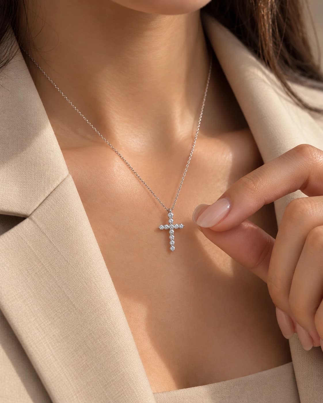 White gold diamond cross pendant on a fine chain, worn